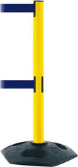 Tensator - 38" High, 2-1/2" Pole Diam, 4 Way Stanchion - 19" Base Diam, Octagon Recycled Rubber Base, Yellow Plastic Post, 7-1/2' x 2" Tape, Dual Line Tape, For Outdoor Use - Benchmark Tooling