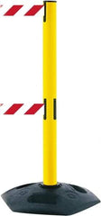 Tensator - 38" High, 2-1/2" Pole Diam, 4 Way Stanchion - 19" Base Diam, Octagon Recycled Rubber Base, Yellow Plastic Post, 13' x 2" Tape, Dual Line Tape, For Outdoor Use - Benchmark Tooling